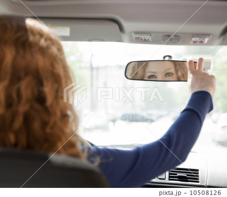 Woman adjusting driving mirror Woman adjusting driving mirror 10508126