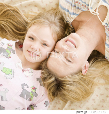 Mother and daughter laying on bed Mother and daughter laying on bed 10508260