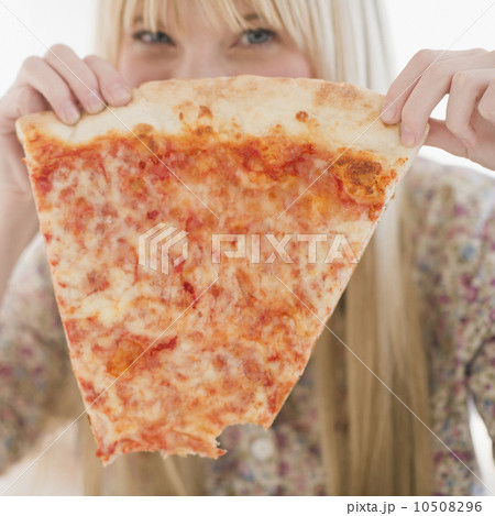 Young woman holding pizza slice 10508296
