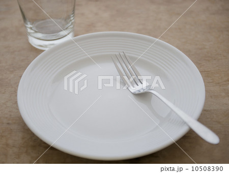 White plate with fork and glass 10508390