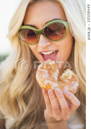 Portrait of teenage girl (16-17) eating doughnut Portrait of teenage girl (16-17) eating doughnut 10508449