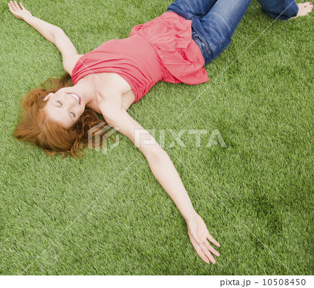 Beautiful woman relaxing on grass Beautiful woman relaxing on grass 10508450