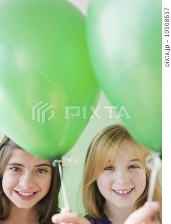 Two girls holding green balloons Two girls holding green balloons 10508637