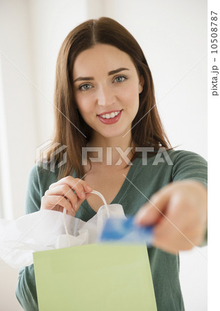 Young woman holding shopping bag and credit card 10508787