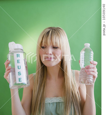 Young woman holding plastic bottles 10509140