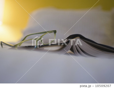 Book and eyeglasses on bed Book and eyeglasses on bed 10509207