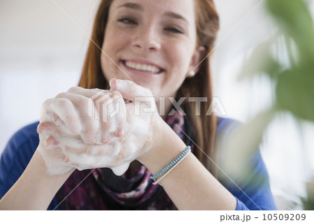 Teenage girl (14-15) washing hands Teenage girl (14-15) washing hands 10509209