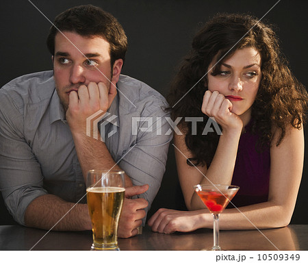 Bored couple sitting at bar counter 10509349