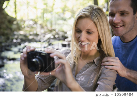 Couple taking picture in forest 10509484