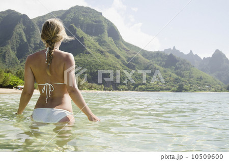 Tunnels Beach, Woman walking in sea 10509600
