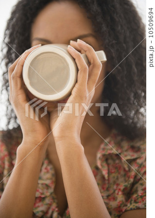 Portrait of woman drinking from coffee mug 10509694