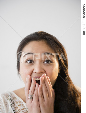 Studio shot of beautiful young woman laughing 10509695