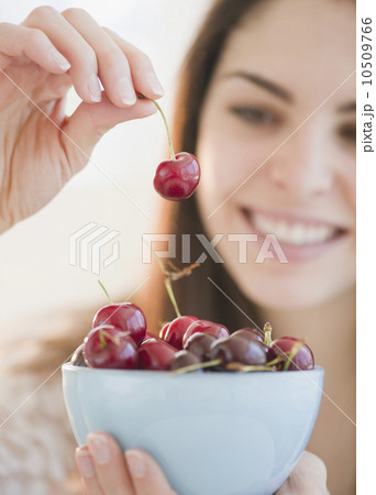 Young woman holding a bowl of cherries Young woman holding a bowl of cherries 10509766