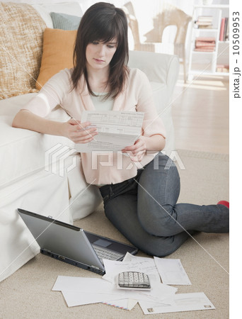 Young woman paying bills via Internet 10509953