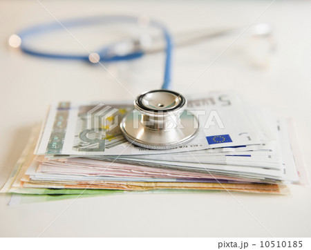Studio shot of stethoscope on banknotes Studio shot of stethoscope on banknotes 10510185