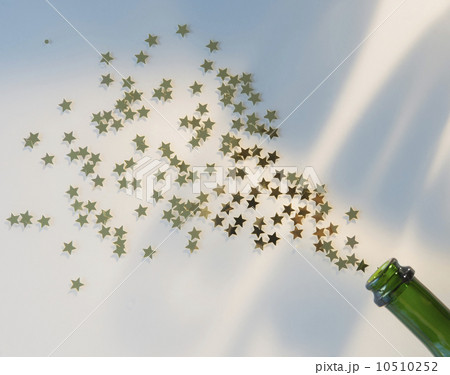 Star shape confetti splashing out of champagne bottle Star shape confetti splashing out of champagne bottle 10510252