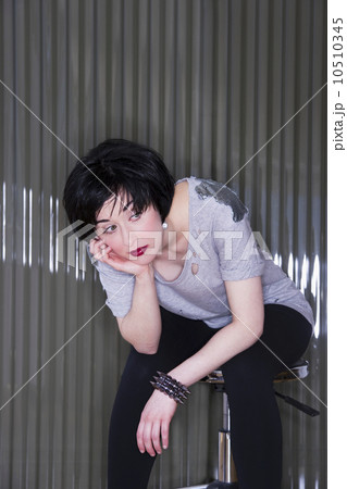 Bored woman slouching on a stool 10510345