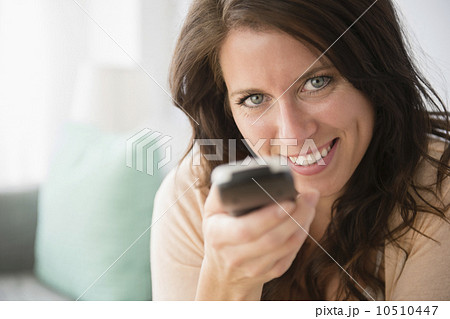 Young woman holding remote control 10510447