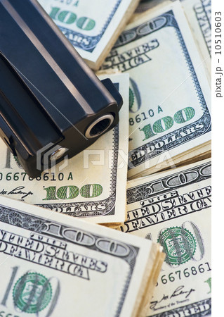 A handgun on stacks of money A handgun on stacks of money 10510603