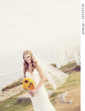 Portrait of bride holding sunflower bouquet Portrait of bride holding sunflower bouquet 10510730