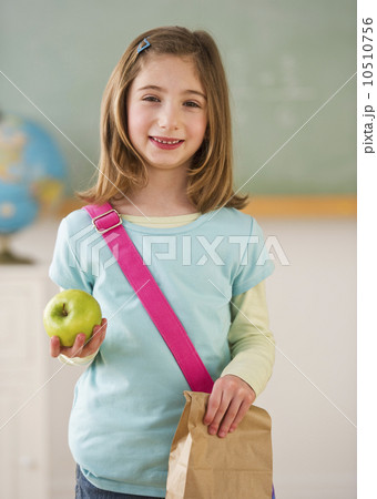Student in classroom holding lunch 10510756