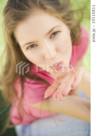 Woman blowing kiss towards camera Woman blowing kiss towards camera 10510811