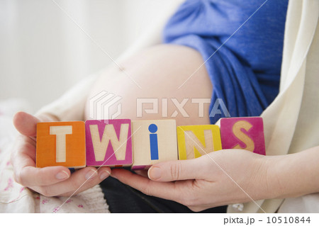 Pregnant woman holding wooden blocks  10510844