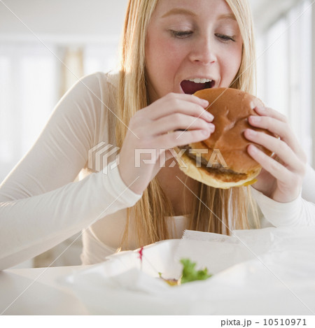 USA, New Jersey, Jersey City, woman eating hamburger USA, New Jersey, Jersey City, woman eating hamburger 10510971