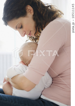 Mother embracing baby boy (2-5 months) Mother embracing baby boy (2-5 months) 10511145