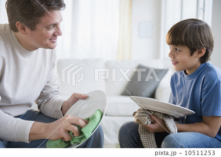 Father and son (8-9) drying dishes Father and son (8-9) drying dishes 10511253