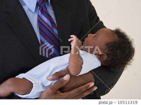 Businessman holding baby 10511319