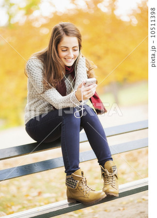 Young woman using cell phone in Central Park 10511398
