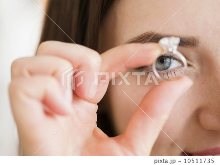 Young woman holding engagement ring 10511735