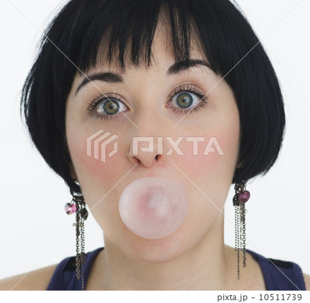 Woman blowing a bubble with bubble gum Woman blowing a bubble with bubble gum 10511739