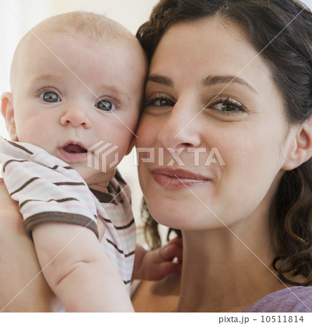 Mother and baby boy (2-5 months) posing together 10511814