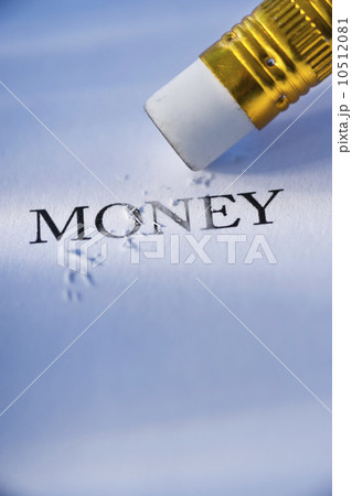 Studio shot of pencil erasing the word money from piece of paper 10512081