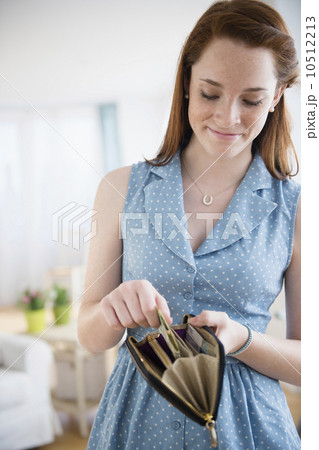 Teenage girl (14-15) with wallet Teenage girl (14-15) with wallet 10512213