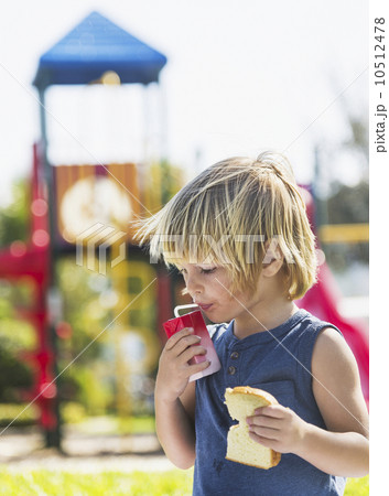 Boy (4-5) running in cape 10512478
