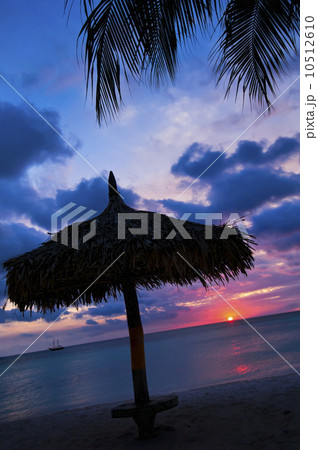 Aruba, silhouette of palapa on beach at sunset Aruba, silhouette of palapa on beach at sunset 10512610