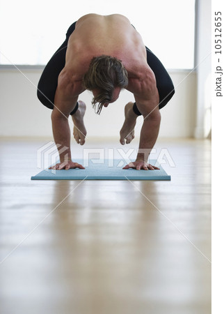 Man doing workout on yoga mat 10512655