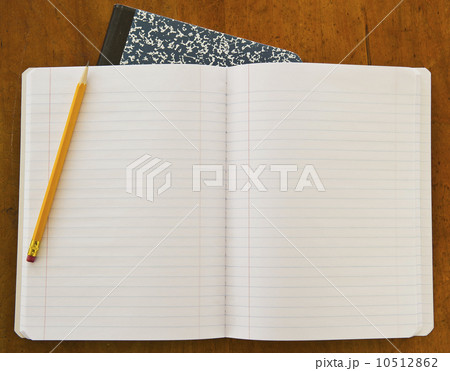Studio shot of open notebook with yellow pencil 10512862