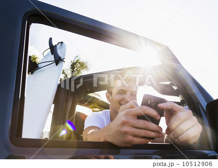 Young man using mobile phone 10512906