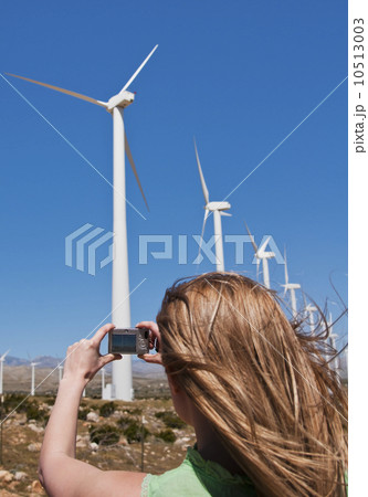 USA, California, Palm Springs, Woman photographing wind turbines with digital camera USA, California, Palm Springs, Woman photographing wind turbines with digital camera 10513003