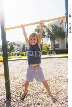 Boy (4-5) playing on playground 10513050