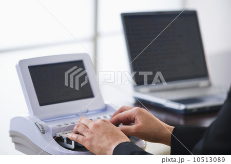 USA, Jersey City, New Jersey, court stenographer using stenograph machine 10513089