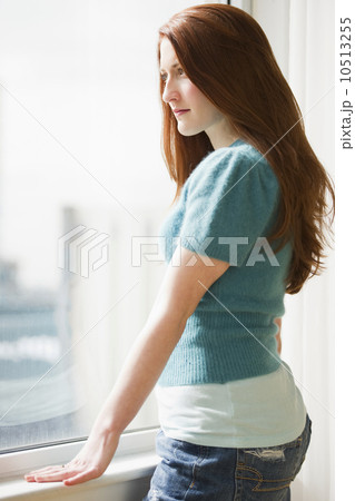 Woman looking out window 10513255