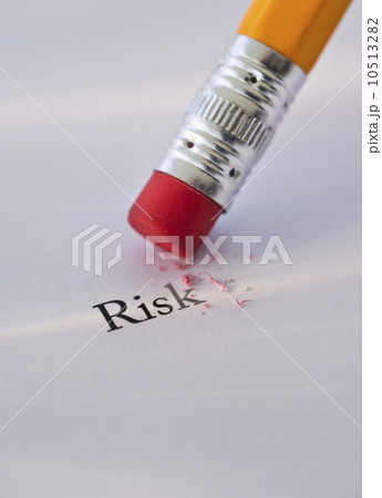 Studio shot of pencil erasing the word risk from piece of paper 10513282