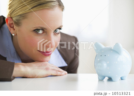 Portrait of businesswoman with piggy bank 10513321