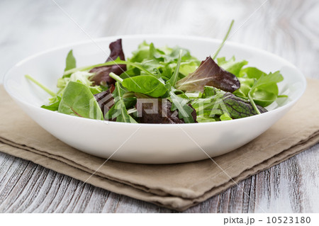 mesclun mix salad in white bowl 10523180