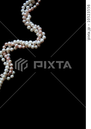 White and pink pearls on a black velvet 10523556